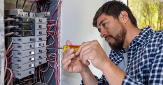 man installing a new electrical panel