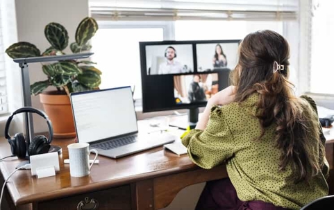 woman working on laptop in home office setting