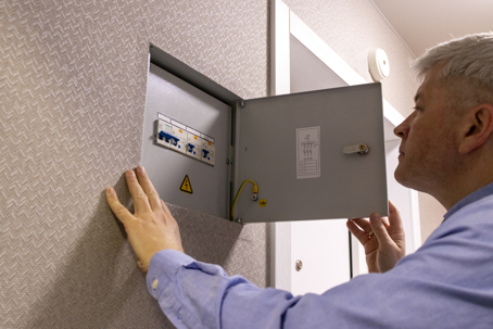 man checking a circuit breaker